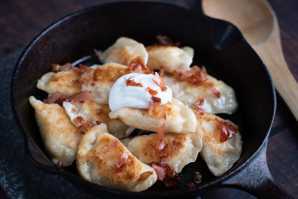 Fried Double Smoked Bacon and Potato Pierogi in a skillet