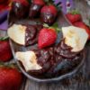 Chocolate-Dipped Strawberry Pierogi, on a plate with fresh strawberries
