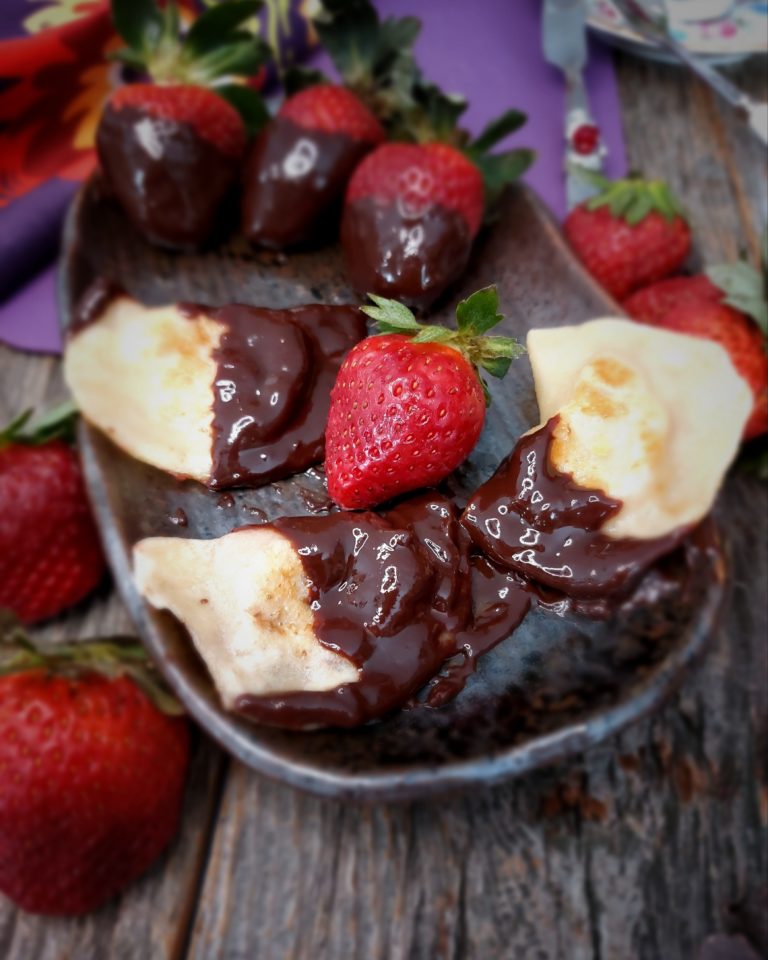 Chocolate-Dipped Strawberry Pierogi, on a plate with fresh strawberries